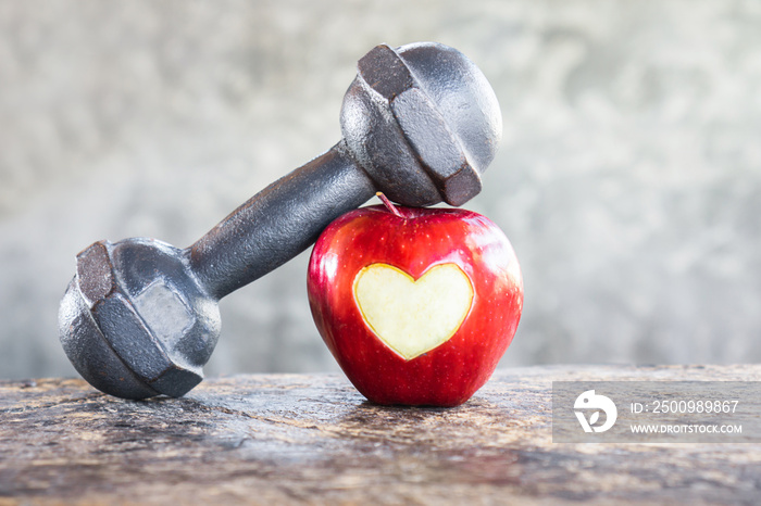 red apple with dumbbells , sport diet ,heart healthy concept