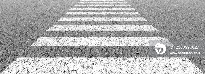 Empty highway black asphalt road and white dividing lines, Crosswalk on the road for safety when people walking across the street, Pedestrian crossing on a repaired asphalt road, Safety First