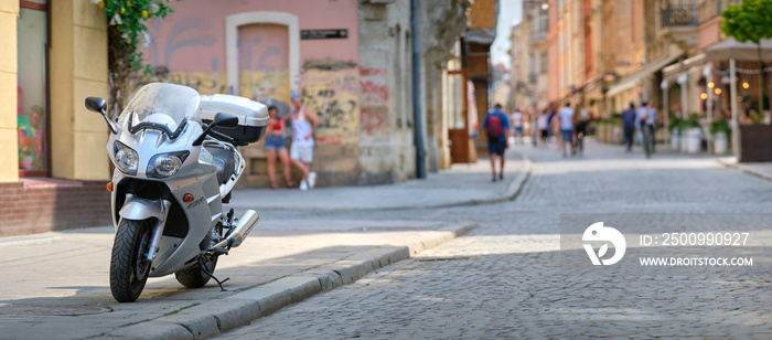 Close up of a motorcycle parked on city street side