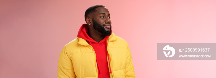 Dreamy happy optimistic black bearded man looking left daydreaming recalling nice moments, enjoying warm peaceful weather walking park feel calm relieved, standing pink background smiling cute