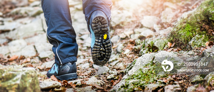 Hiking boots detail in summer light rocks mountains.