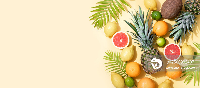 Summer tropical banner or background with fresh fruits and palm leaves