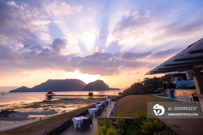 Langkawi, Malaysia: An outdoor dining scene at a resort hotel in beautiful island setting at sunset