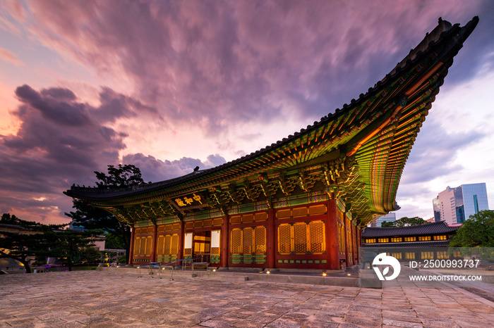 Side view of Junghwajeon the main hall of Deoksugung Palace at sunset. Inscriptions under the roof means Junghwajeon and name the hall. Seoul, South Korea.