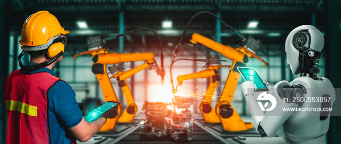 Mechanized industry robot and human worker working together in future factory . Concept of artificial intelligence for industrial revolution and automation manufacturing process .