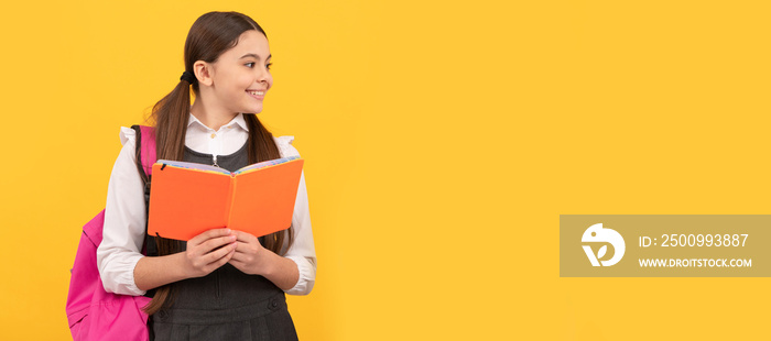 Learning for life. Happy children read books yellow background. Portrait of schoolgirl student, studio banner header. School child face, copyspace.