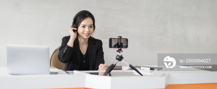 Stock photo of a Southeast Asian Ethnic business woman student teacher tutor video conference calling on laptop computer talk by webcam learn teach in online chat, distance online teaching concept