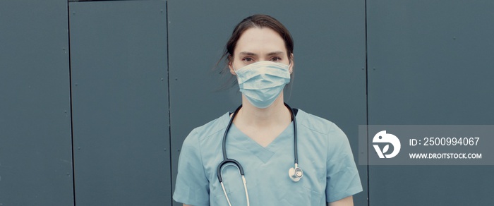 FRONT Portrait of tired nurse or doctor wearing medical mask looking into camera. COVID-19, Coronavirus pandemic