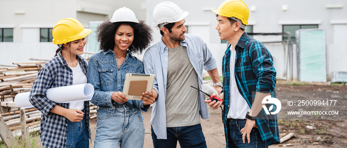 Specialists use tablets on the job site. Civil Engineer, Architect, Business Investor, and General Worker Discussing Building Plans.