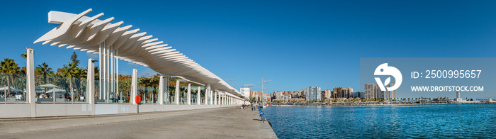 Panorama of  Palmeral de las sorpresas . an architectural structure in the the promenade of the port of Malaga.  Muelle Uno  shopping mall,Malagueta buildings, main park and La Farola lighthouse.