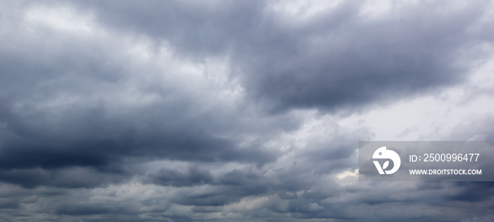 The dark sky with heavy clouds converging and a violent storm before the rain.Bad weather sky..