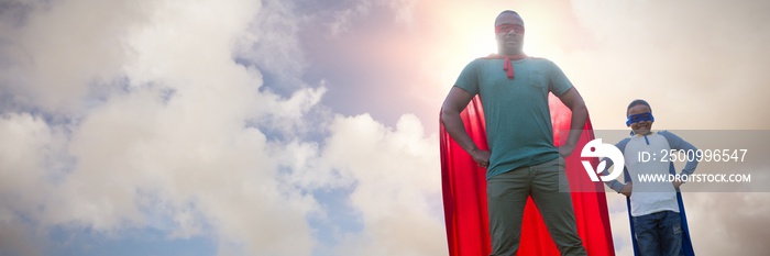 Composite image of father and son pretending to be superhero