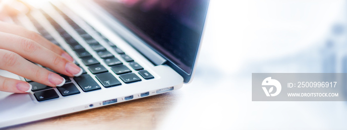 Business woman working on modern computer banner or panorama. Person buying online at internet. Laptop keyboard detail with hands copy space for text.