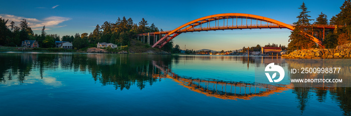 Panoramic landscape of Rainbow Bridge and mirror reflections on the Swinomish Channel near Skagit Bay in La Conner of Washington State