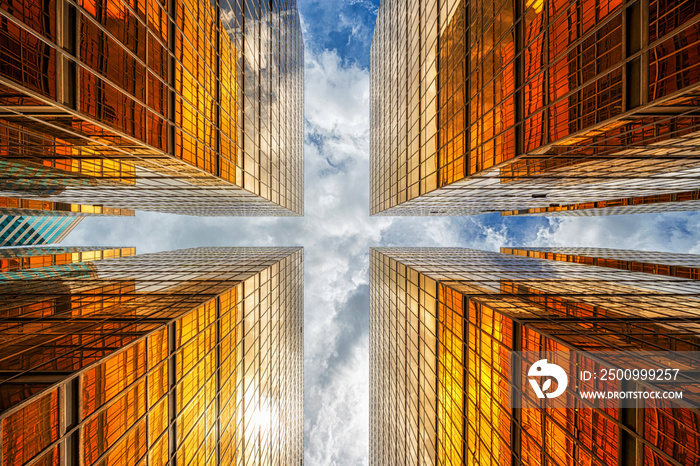 Uprisen angle of Hong Kong skyscraper with reflection of clouds among high building, Building glasses, business and financial, Architecture and industrial concept