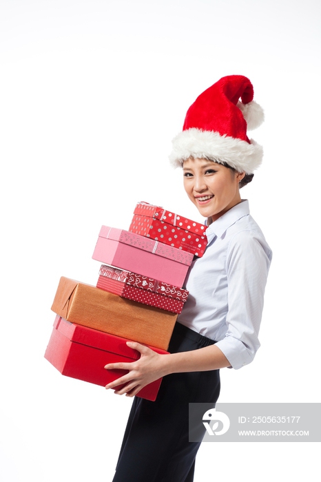 棚拍戴圣诞帽的年轻商务女士抱着礼物盒