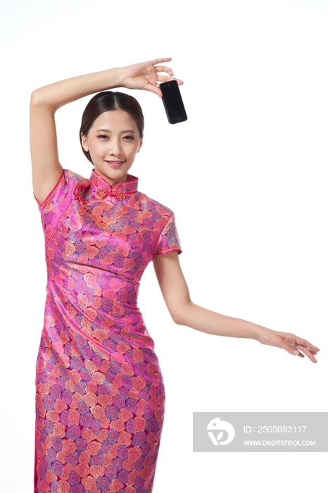 棚拍身穿中国传统服装的年轻女人展示手机