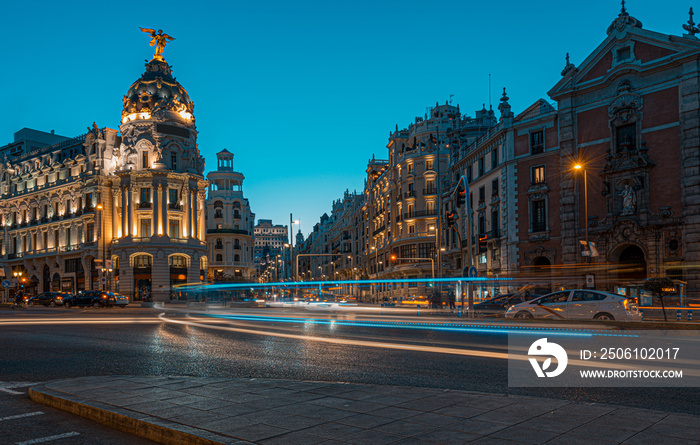 Lighttrails and Traffic on the crossing Alcala and Gran Via street in Madrid by twilight.The Gran Vi