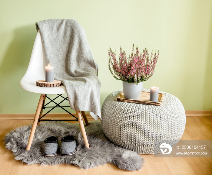 Plastic chair with wood legs covered with gray wool plaid, knitted pattern plastic table, fake sheep