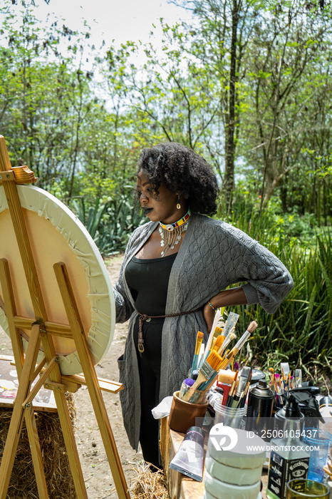 young woman outside painting