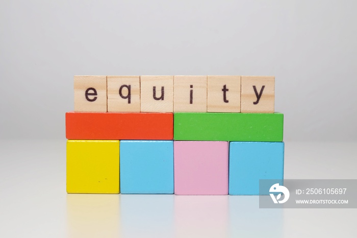 The word equity with wooden block