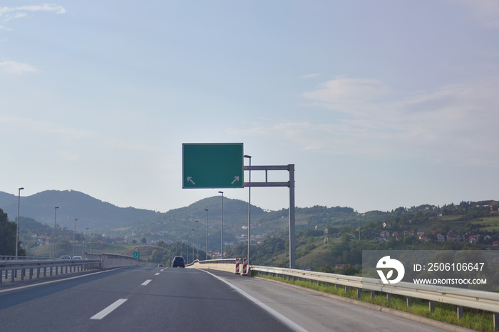 Highway and  road signs at cloudy day.