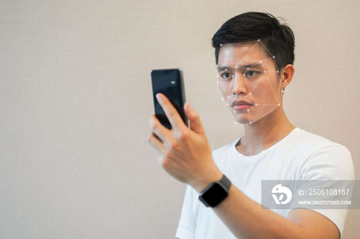 close up young asian man holding smartphone to unlock on device by use function of biometric facial 