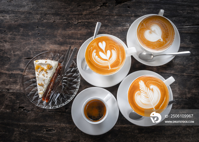 Cup of latte art,capuccino,tea with cake on old wooden table.