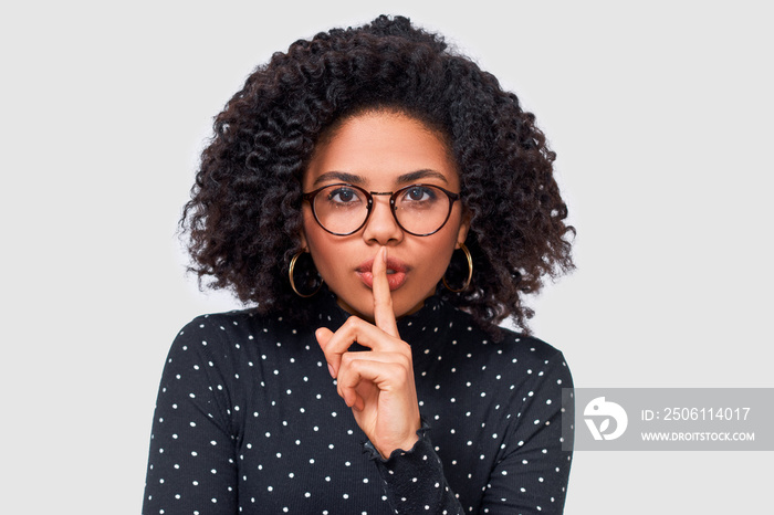 Closeup studio portrait of African American young woman wears black long sleeve shirt, transparent e