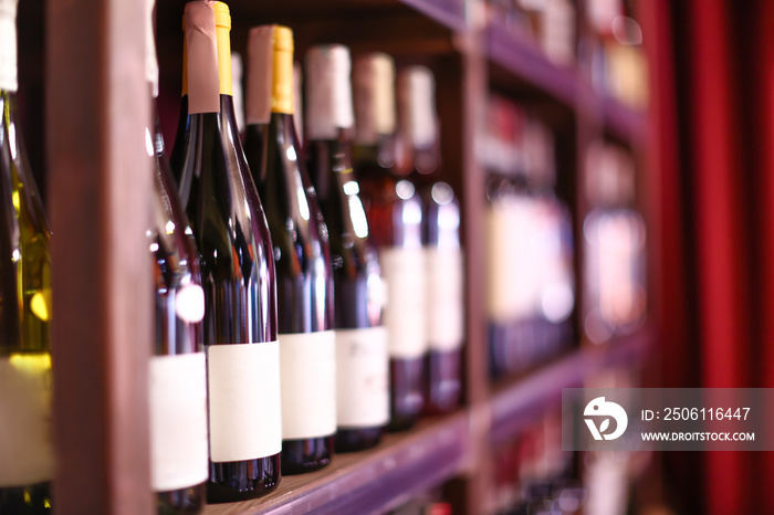 Rack with bottles of wine in store