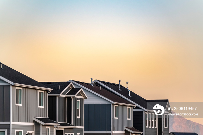 Grey timber clad houses on a housing estate