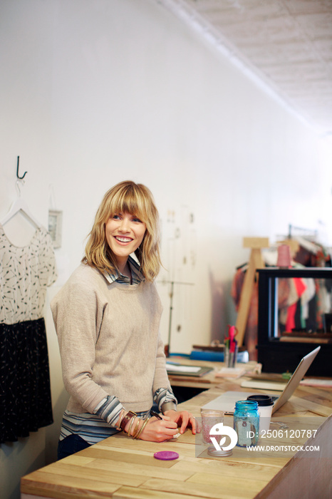 Woman taking notes, smiling