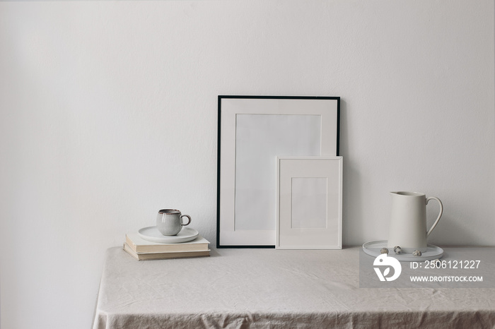 Easter home spring still life. Blank picture frames mockups. Cup of coffee, books on linen table clo