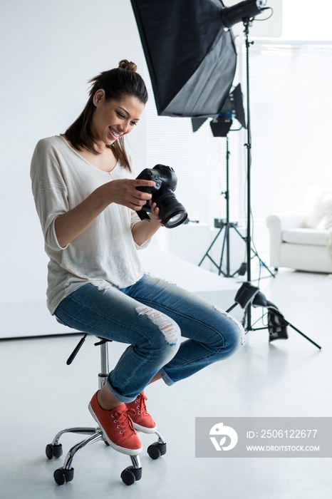 photographer reviewing photos in her camera