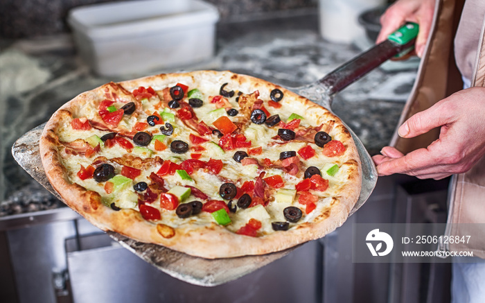 Chef remove delicious pizza with bacon from stove for baked