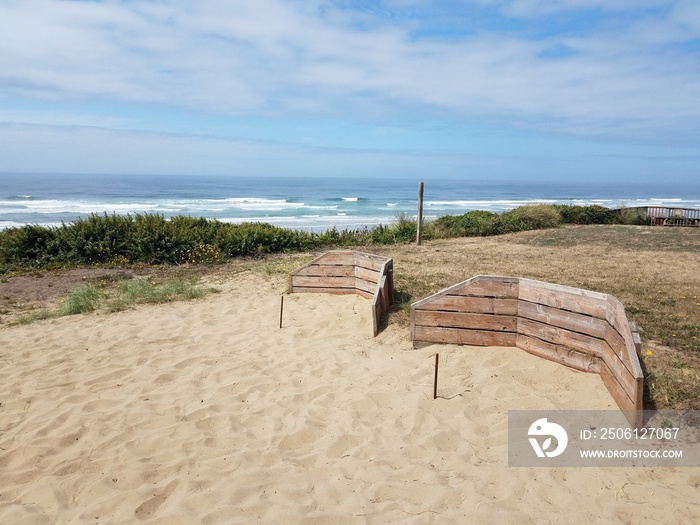 horse shoe pits with sand near beach with ocean waves