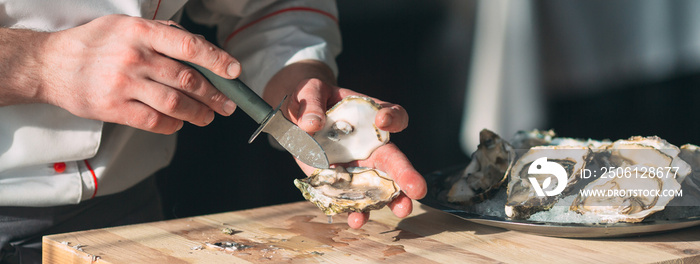 Opening the hollow and flat oysters. Chef opens oysters in the restaurant.