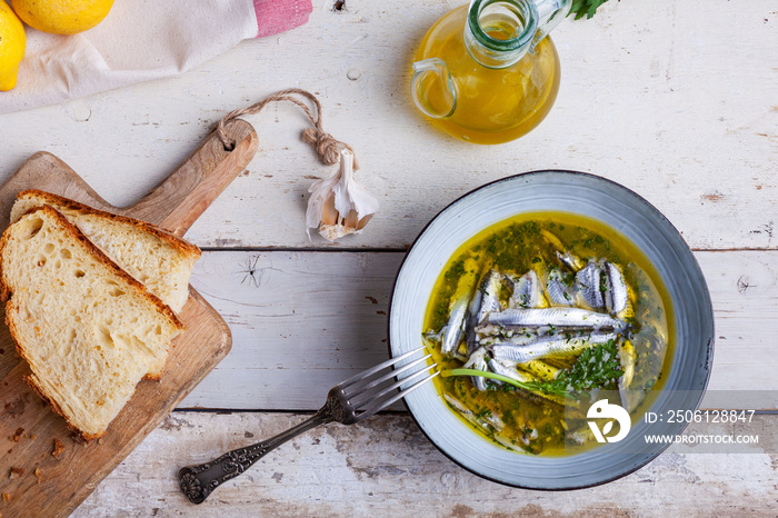 Marinated anchovies in lemon juice with olive oil garlic and parsley