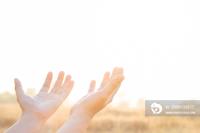 Human hand open palm up worship praying with faith and belief in God of an appeal to the sky and sun