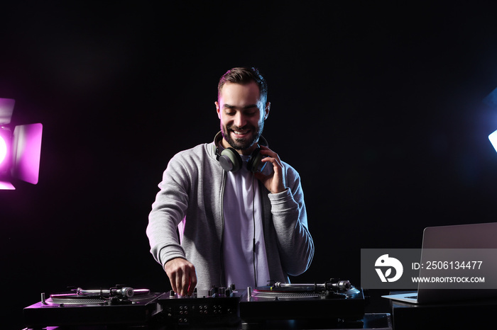 Male DJ playing music in club