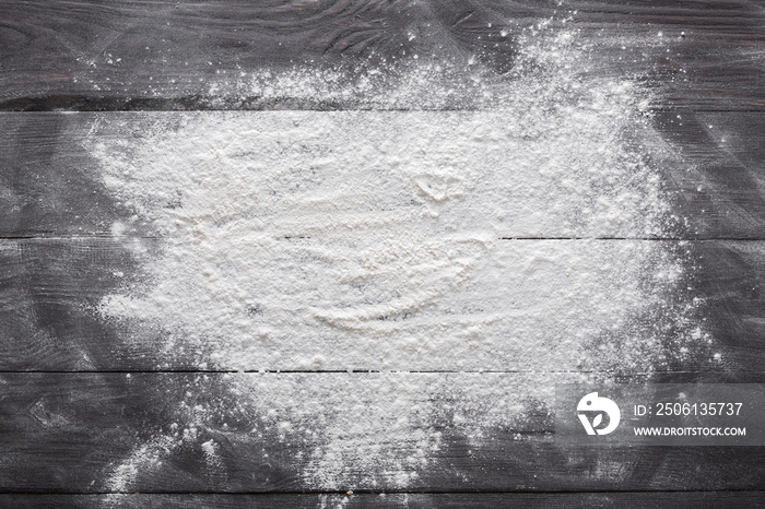 Baking concept on wood background, sprinkled flour with copy space