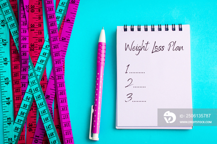 Weight loss and Diet control concept background. Colorful of a Measuring tape on vibrant blue color 