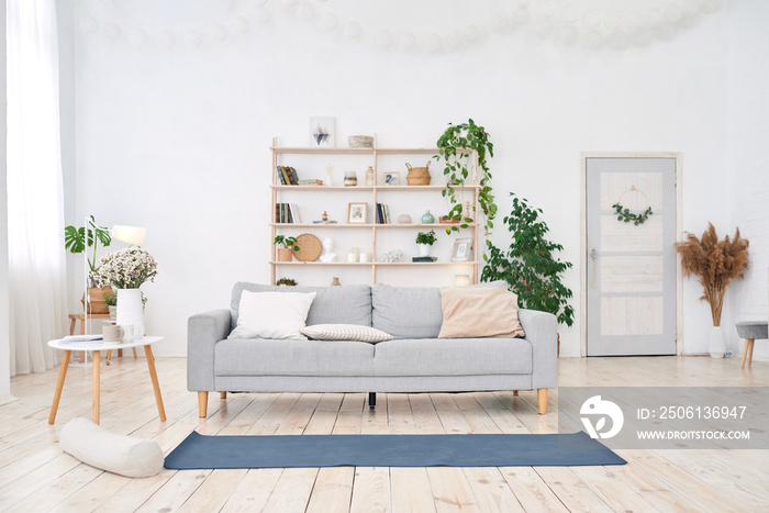 yoga room with big light window in modern flat. Yoga mat on the floor, no people