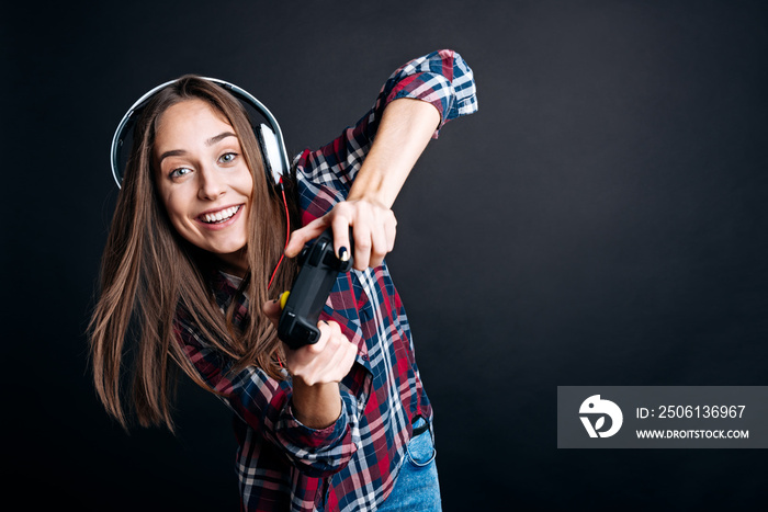 Positive young woman holding game console