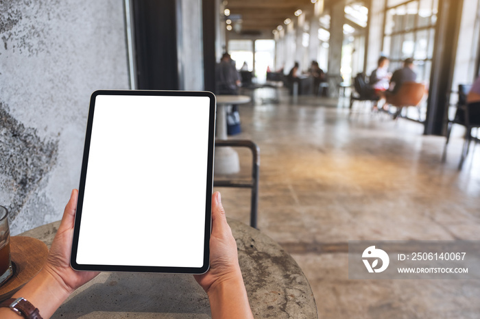 Mockup image of a woman holding digital tablet with blank white desktop screen