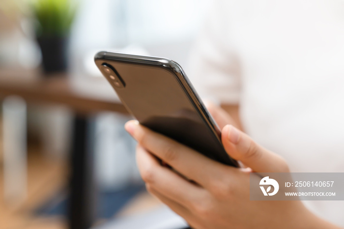 Close up image of hand holding a smartphone.