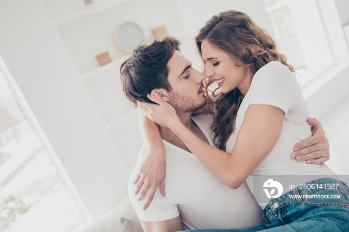 Portrait of lovely romantic couple enjoying recreation indoor wearing white t-shirts. Harmony idylli