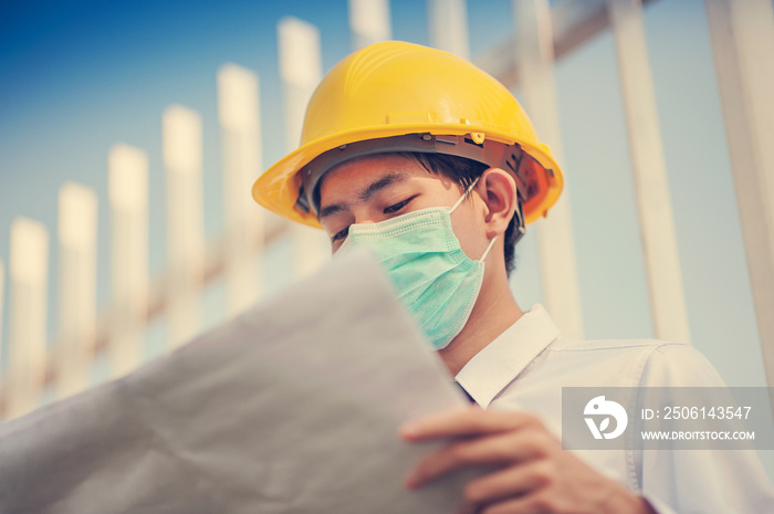 Businessman use surgical mask yellow hard hat holding blueprint inspection construction building est