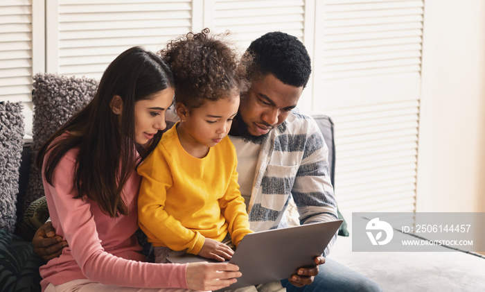 International family looking at tablet at home