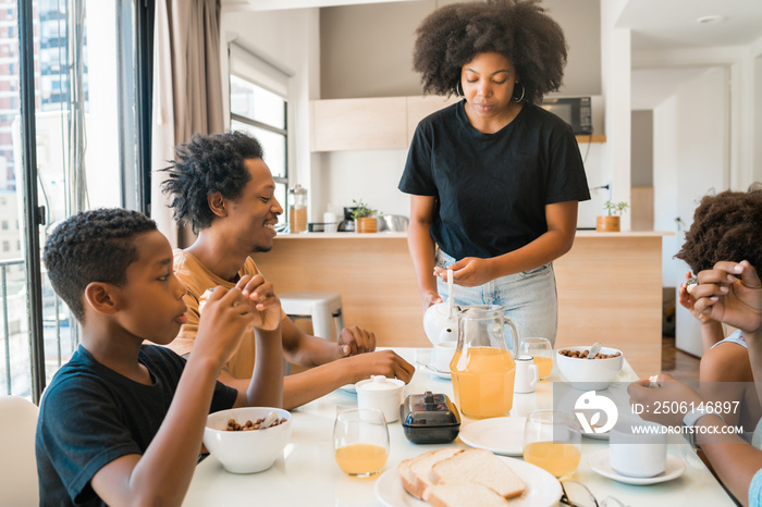 Family having breakfast together at home.